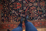 Navy blue Indian Bijar rug's gul ferang motif and brick red meandering vine border.