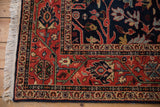 Vintage Indian Bijar rug corner, deep brick red meandering vine border, navy blue field, and fringe.