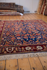 Angled view highlighting the fine wool pile and Herati pattern of a vintage Russian rug.
