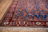 Corner detail of a vintage Russian rug highlighting the burgundy samovar turtle border and full ivory fringe.