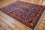 Angled view of a vintage Russian Bijar design rug showing its dense Herati pattern and samovar turtle border.