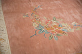 Soft, blankety pile of a Japanese Art Deco carpet showing ornate foliage and fringe detail.
