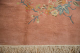 Plush, hand-knotted pile and clean ivory fringe on a dusty rose Art Deco carpet.