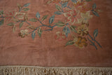 Long stemmed vines and foliage on a plush dusty rose Art Deco carpet with clean ivory fringe.