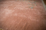 A view across the plush, even pile and soft texture of the carpet's dusty rose field.
