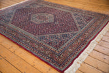 Vintage Indian Bijar carpet close-up: thick plush pile, raspberry red Herati motif, intricate borders.