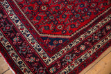 Detailed corner of a vintage Engelas rug showing its intricate navy and ivory borders.