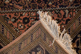 Intact ivory fringe and side cord selvage on a vintage Ardebil rug's intricate border.