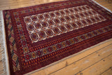 Intact ivory cord selvage along the cherry red geometric border of the vintage Bokhara rug.