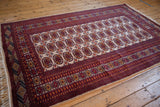 Indian Bokhara design carpet with multi-column gul medallions, full pile, and intact selvages.