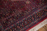 Vintage Indian Bijar rug corner showcasing raspberry Herati motif, navy border, and plush pile.