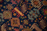 Close-up of the Indian carpet's bounty of animal and geometric motifs on a cobalt blue field.