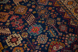 Detail of colorful plant and animal designs on the cobalt blue field of a vintage Shiraz carpet.
