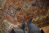 Vintage Indian Shiraz carpet, a diamond medallion and botanical field in chestnut brown and navy.