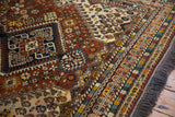 Soft brown fringe and intricately patterned borders of a vintage Indian Shiraz rug.