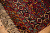 Intact side cord and thick beige fringe on a hand-knotted vintage Afshar design carpet corner.