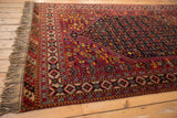 Full fringe and intricate geometric border on the corner of a vintage Afshar design carpet.