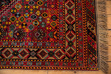 Intricate geometric borders and full wool pile on the corner of a vintage red Afshar design carpet.