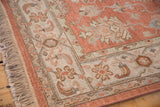 Traditional Indian Mahal rug border detail in terracotta, ivory, and seafoam floral motifs.