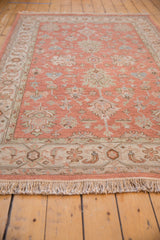 Ivory fringe and patterned border of an Indian Mahal rug featuring slate blue, seafoam, and dusty rose.