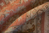 Textured hand-knotted pile of rolled Indian Mahal rug in pale terracotta and slate blue.