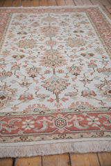 Pale terracotta dusty rose border and ivory fringe detail of a hand-knotted Indian Mahal carpet.
