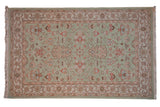 Seafoam Indian Mahal carpet with oversized floral palmettes and pale terracotta blossoms.