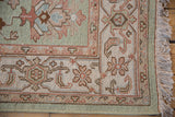 Hand woven Indian Mahal rug corner, seafoam and terracotta floral motifs with fringe.