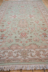 Close-up of pale terracotta and ivory border, seafoam field, and fringe.