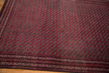 Angled view showcasing the tightly woven, repeating gul motif of a vintage Beljic rug.
