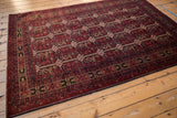 Intact charcoal navy side cord selvage and cherry red border of this Belouch design rug.