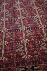 Cherry red and navy Pakistani Belouch design featuring vinery, botehs, and germinating plant motifs.