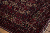 Pakistani Belouch rug corner with cherry red intertwined vinery and detailed boteh motifs.