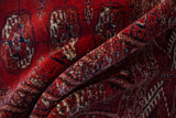 Soft folds reveal the plush, lustrous wool pile of a vintage Pakistani Bokhara rug.