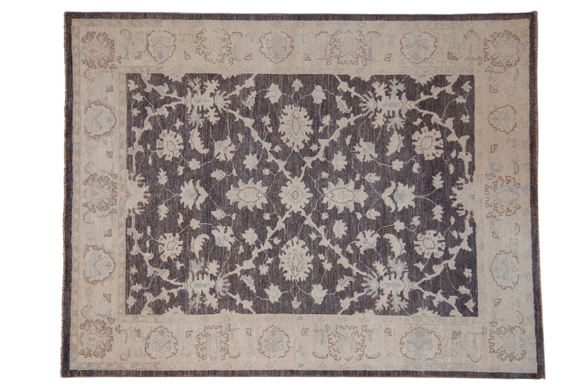 Hand-knotted Peshawar rug with floral palmettes in ivory and powder blue over a charcoal field with a beige border.