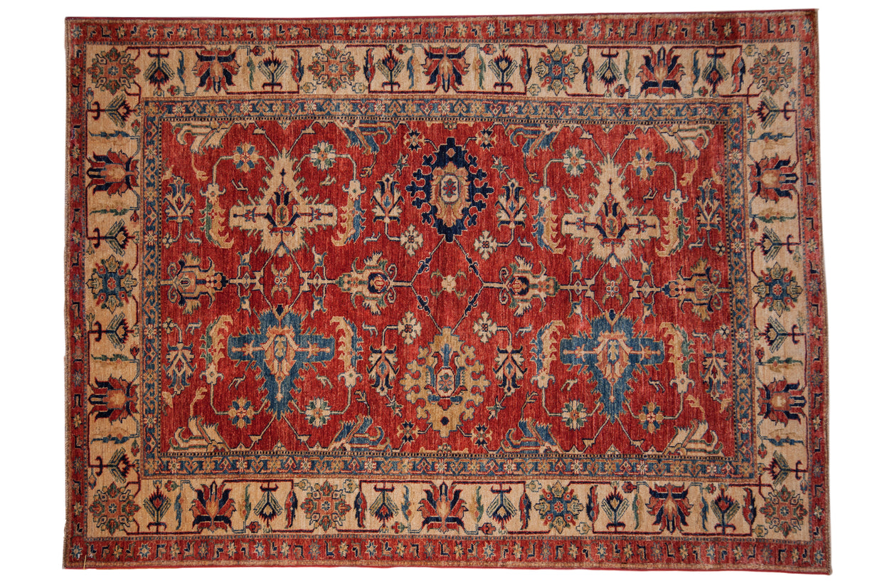 Pakistani Caucasian hand-knotted carpet, cherry red field, sapphire blue palmettes.