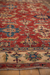 Geometric design detail of a Pakistani Caucasian style rug in cherry red, blue, and ivory.