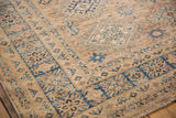 Detailed geometric blue motifs and fine weave border on a Pakistani Caucasian rug.