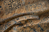 Fine wool pile with detailed geometric blue motifs on a beige Pakistani Caucasian rug.