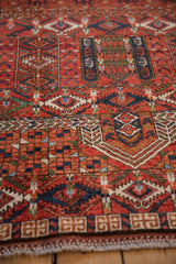Detailed geometric weave on a Pakistani Turkmen rug, showcasing cherry red, indigo, and intact selvage.