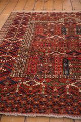 Pakistani Turkmen design rug showing rich cherry red and indigo geometric patterns.