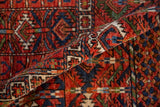 Lustrous cherry red and indigo geometric wool pile with intricate pattern and intact side selvage.
