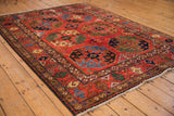 Detailed geometric weave, large palmettes, and gem shades on a Pakistani Ersari rug.