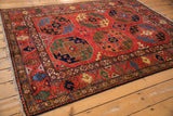 Rich cherry red Pakistani Ersari rug with bold geometric palmettes in sapphire and emerald.