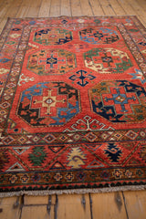Light beige fringe and geometric border with cherry red, emerald green, sapphire blue.