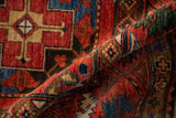 Intricate geometric patterns and rich gem tones on the rolled Ersari design rug.