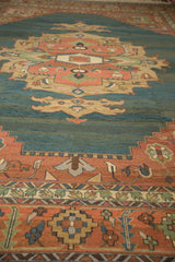 Vintage Serapi rug's abrashed dusty teal field and terra cotta geometric floral border.
