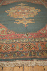 Serapi Indian Soumac rug lower border featuring serrated leaf motifs, terra cotta, and ivory fringe.