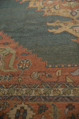 Vintage Serapi rug detail: dusty teal abrashed field, terra cotta serrated leaf, floral motifs.