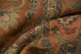 Serapi rug pile with serrated leaf and geometric floral motifs in terracotta and dusty teal.